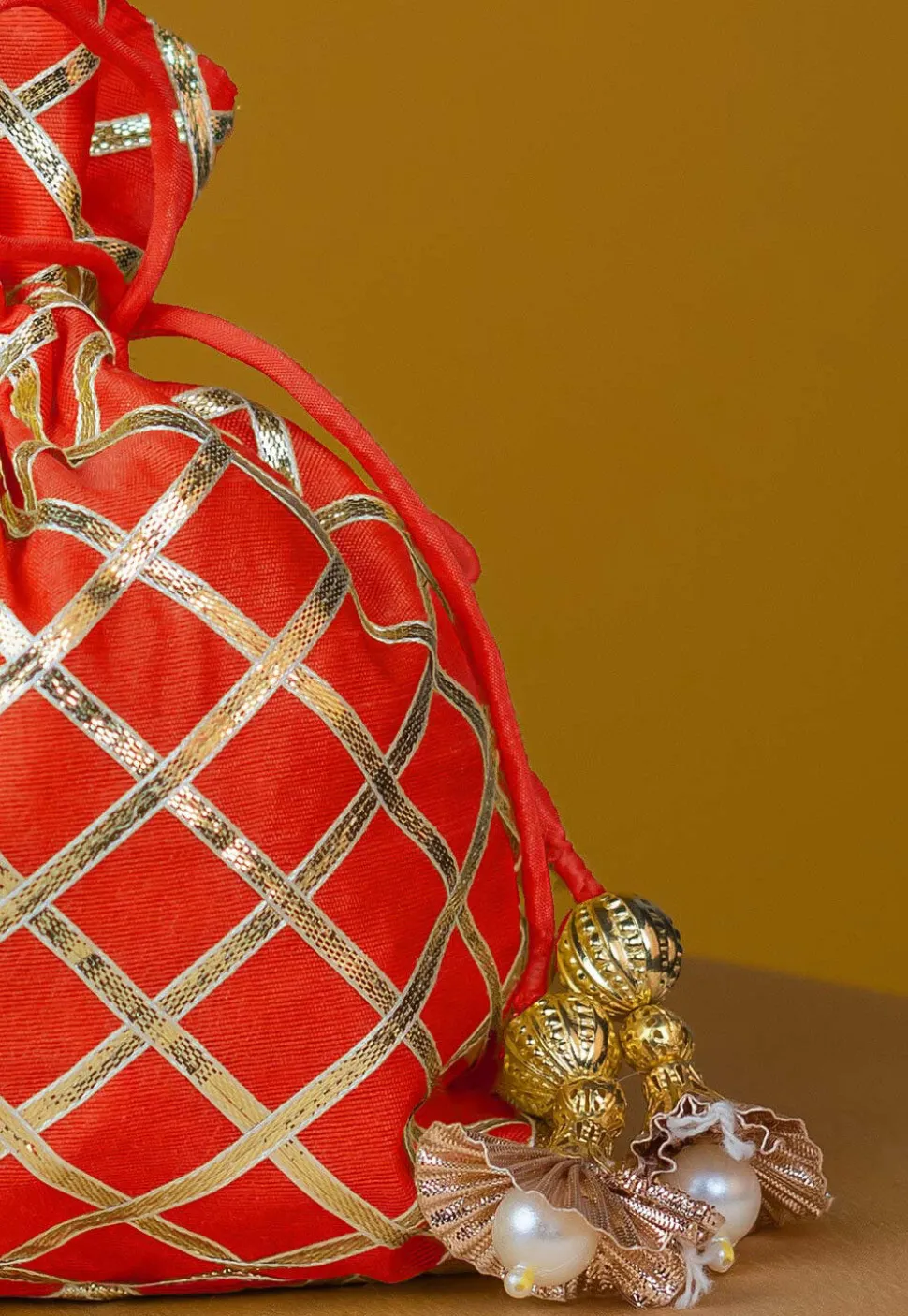 Embroidered Art Silk Potli Bag in Orange