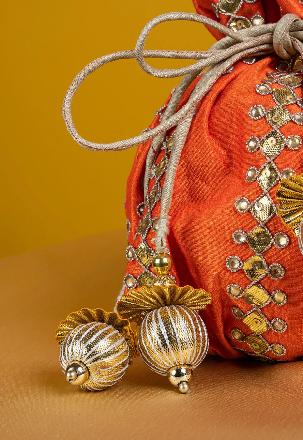 Embroidered Art Silk Potli Bag in Orange
