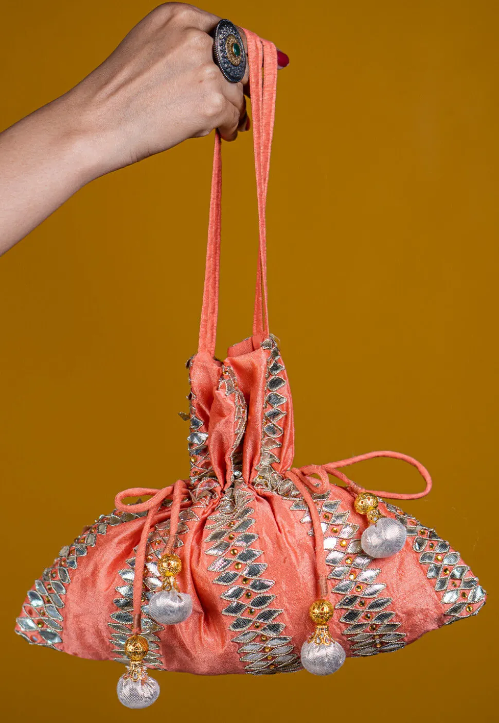 Embroidered Art Silk Potli Bag in Peach