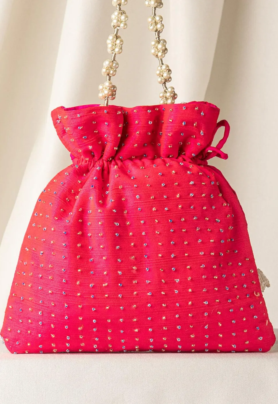 Hand Embroidered Art Silk Potli Bag in Fuchsia