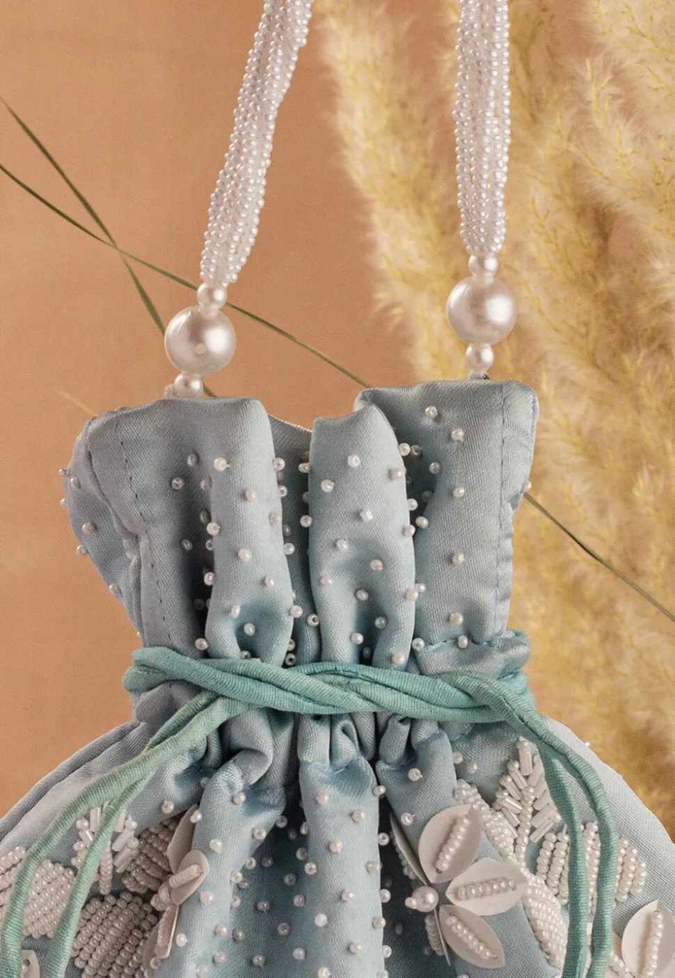 Hand Embroidered Art Silk Potli Bag in Pastel Blue