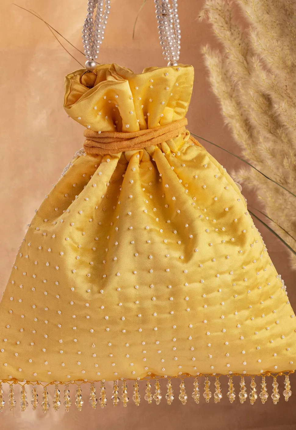 Hand Embroidered Art Silk Potli Bag in Mustard