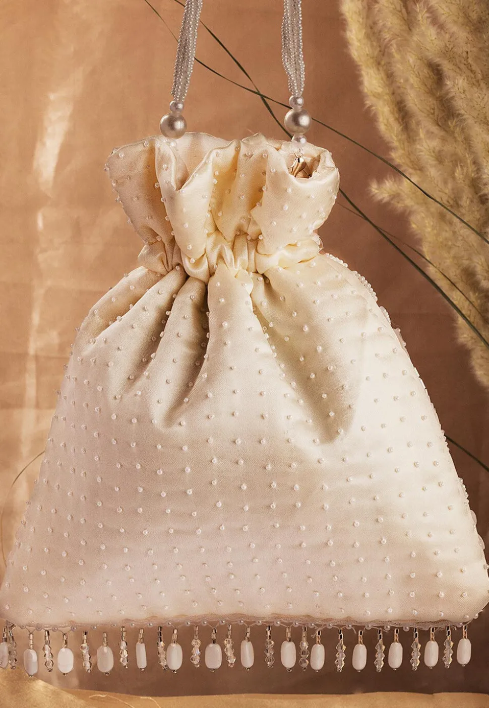 Hand Embroidered Art Silk Potli Bag in Off White