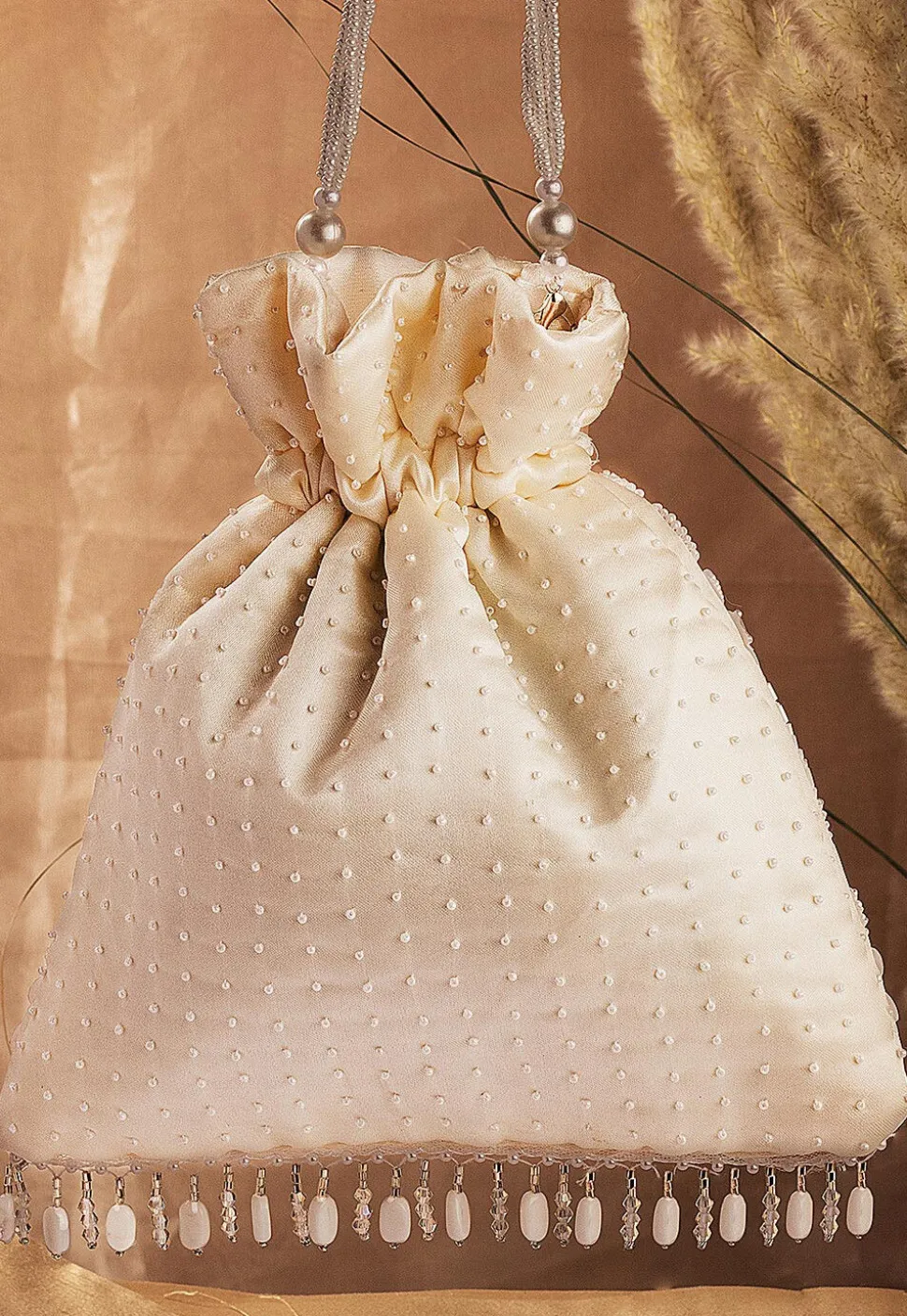 Hand Embroidered Art Silk Potli Bag in Cream